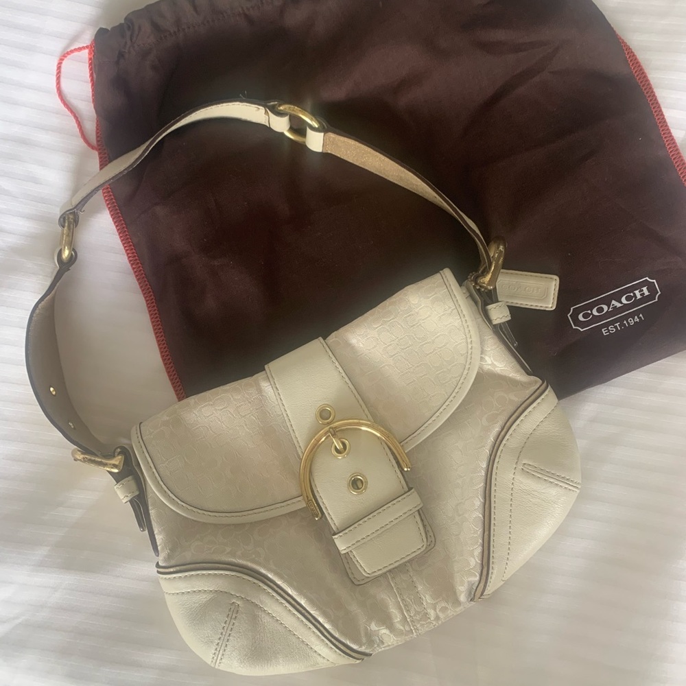 Original white Coach bag with duster. Pink interior. Some scuffs on buckles.